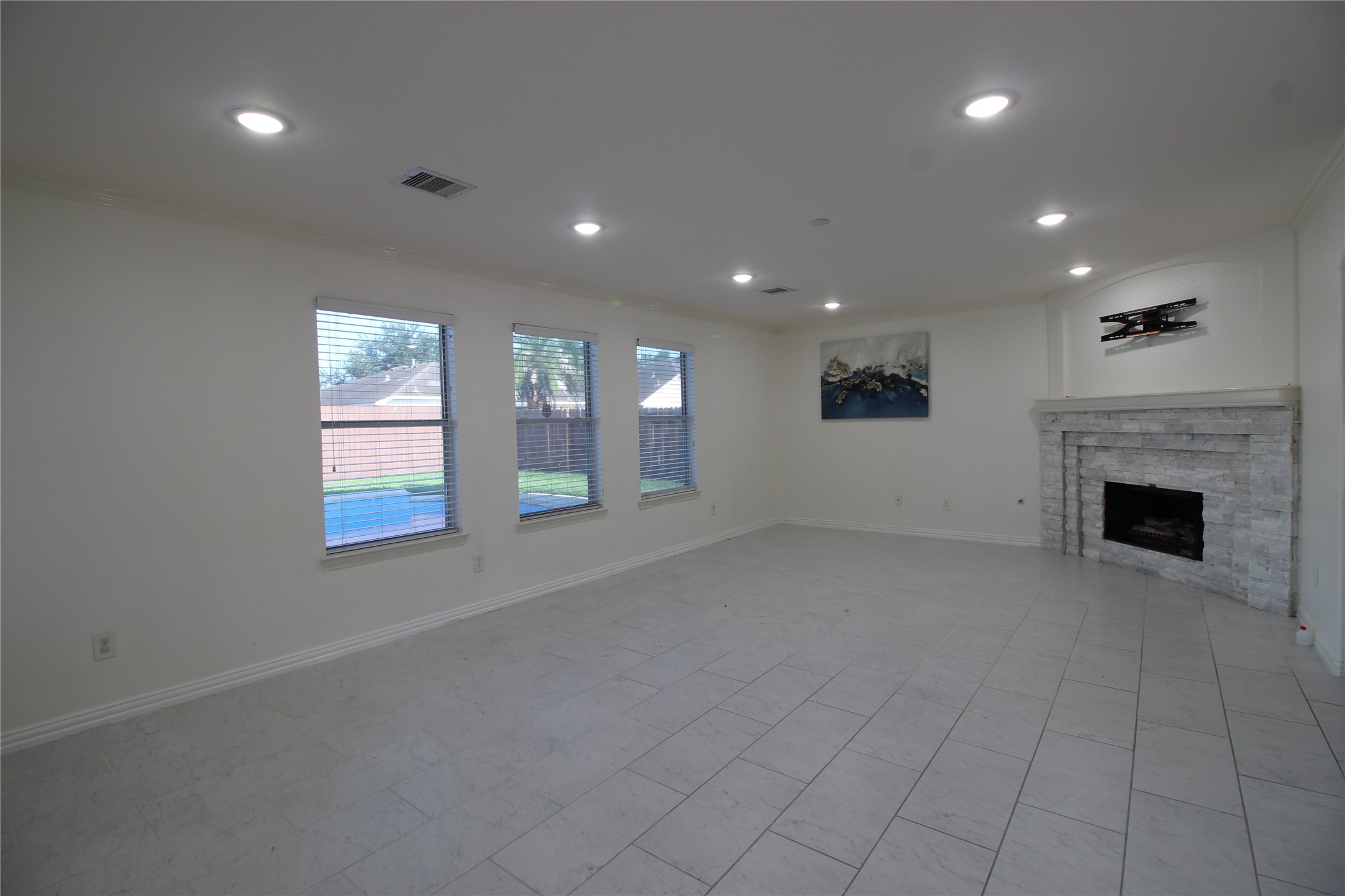 8314 Silver Fir Lane Baytown, TX 77523 - Photo 5 of 22 an empty room with windows and fireplace