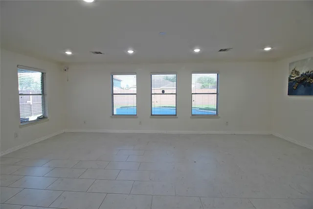 a view of an empty room with windows