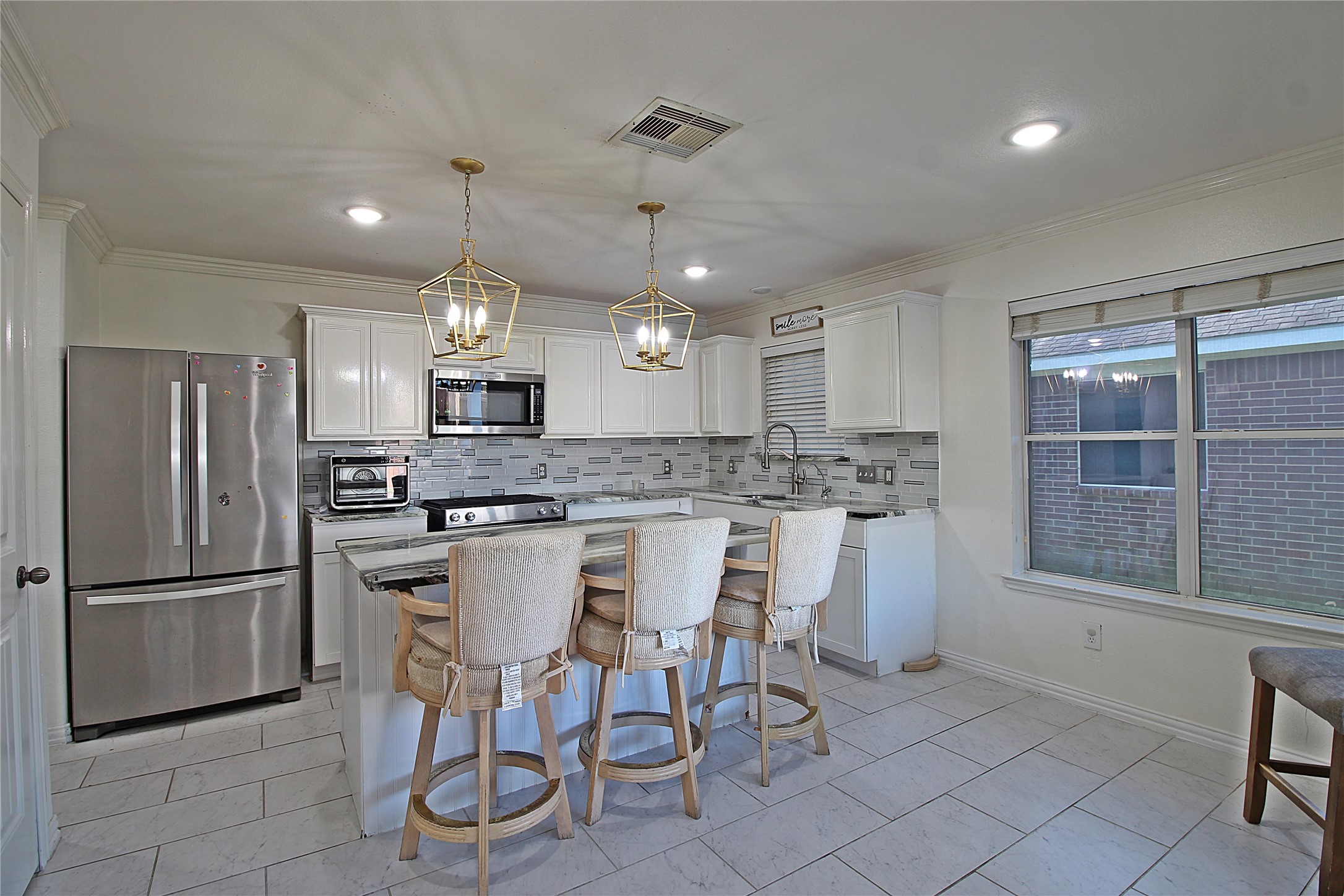 8314 Silver Fir Lane Baytown, TX 77523 - Photo 7 of 22 a kitchen with stainless steel appliances granite countertop a refrigerator a sink dishwasher a dining table and chairs with wooden floor