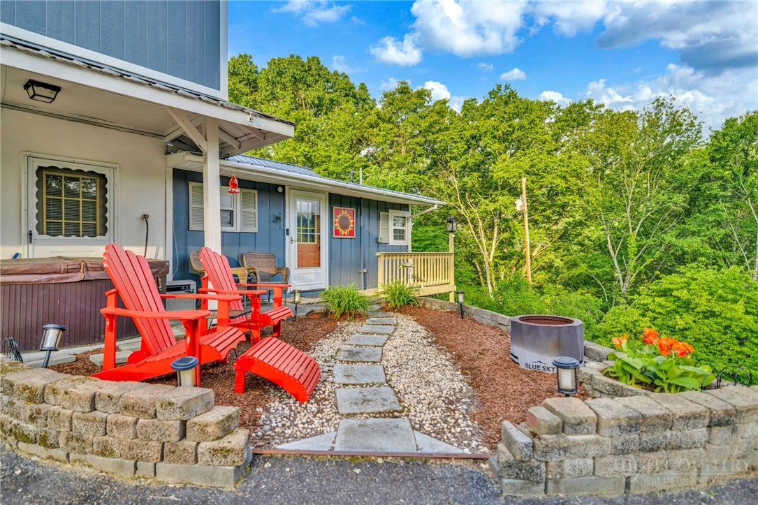 242 Ladd Parson Road Crumpler, NC 28617 - Photo 4 of 36 a view of a house with backyard sitting area and garden
