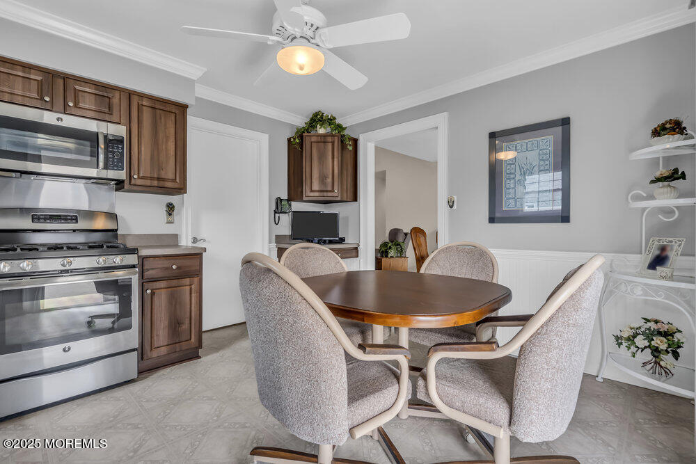 15 Rita Drive Howell, NJ 07731 - Photo 15 of 26 a living room with stainless steel appliances kitchen island granite countertop a sink a stove a dining table and chairs with wooden floor