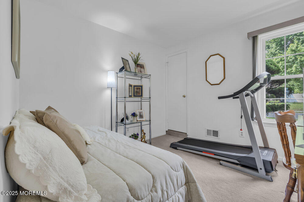 15 Rita Drive Howell, NJ 07731 - Photo 18 of 26 a bedroom with a bed and a chandelier