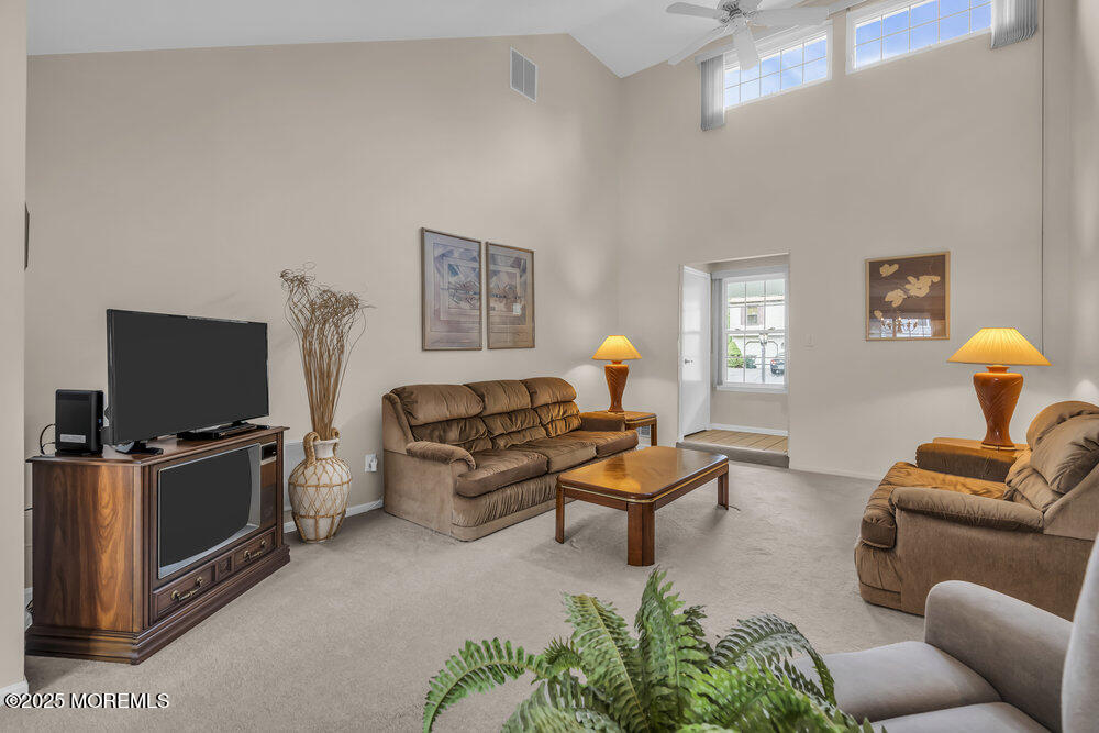 15 Rita Drive Howell, NJ 07731 - Photo 8 of 26 a living room with furniture and a flat screen tv