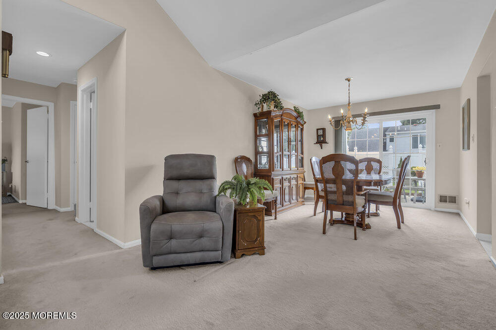 15 Rita Drive Howell, NJ 07731 - Photo 9 of 26 a living room with furniture and a chandelier