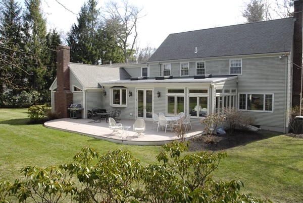 61 Dean Road Weston, MA 02493 - Photo 1 of 10 a view of a house with backyard sitting area and garden