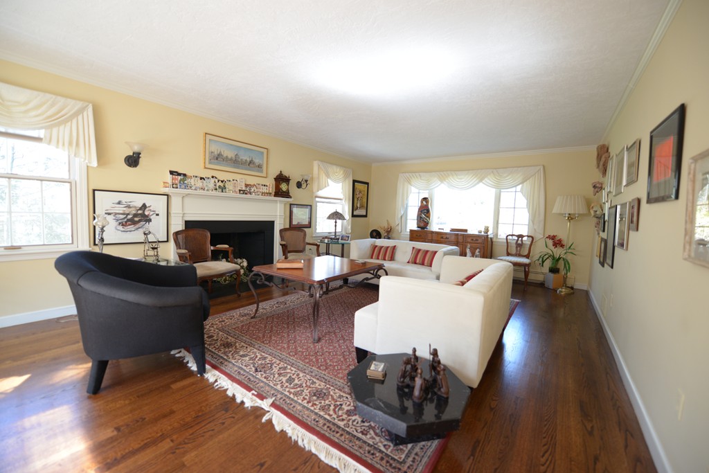 61 Dean Road Weston, MA 02493 - Photo 4 of 10 a living room with furniture fireplace and a large window