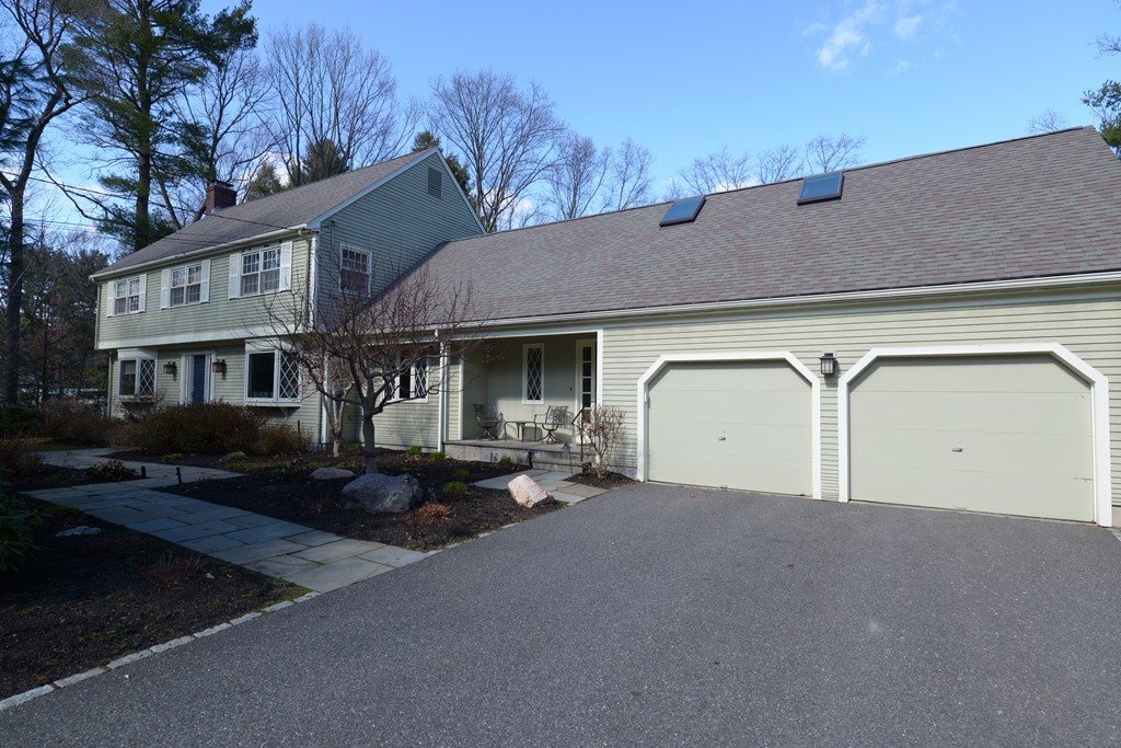 61 Dean Road Weston, MA 02493 - Photo 10 of 10 a front view of a house with a yard and garage