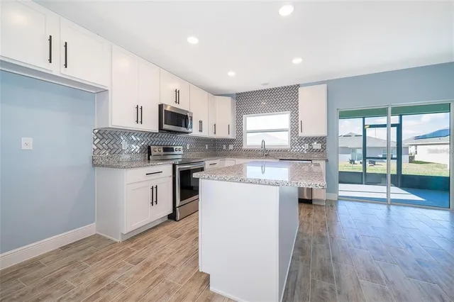 a kitchen with a sink cabinets and stainless steel appliances