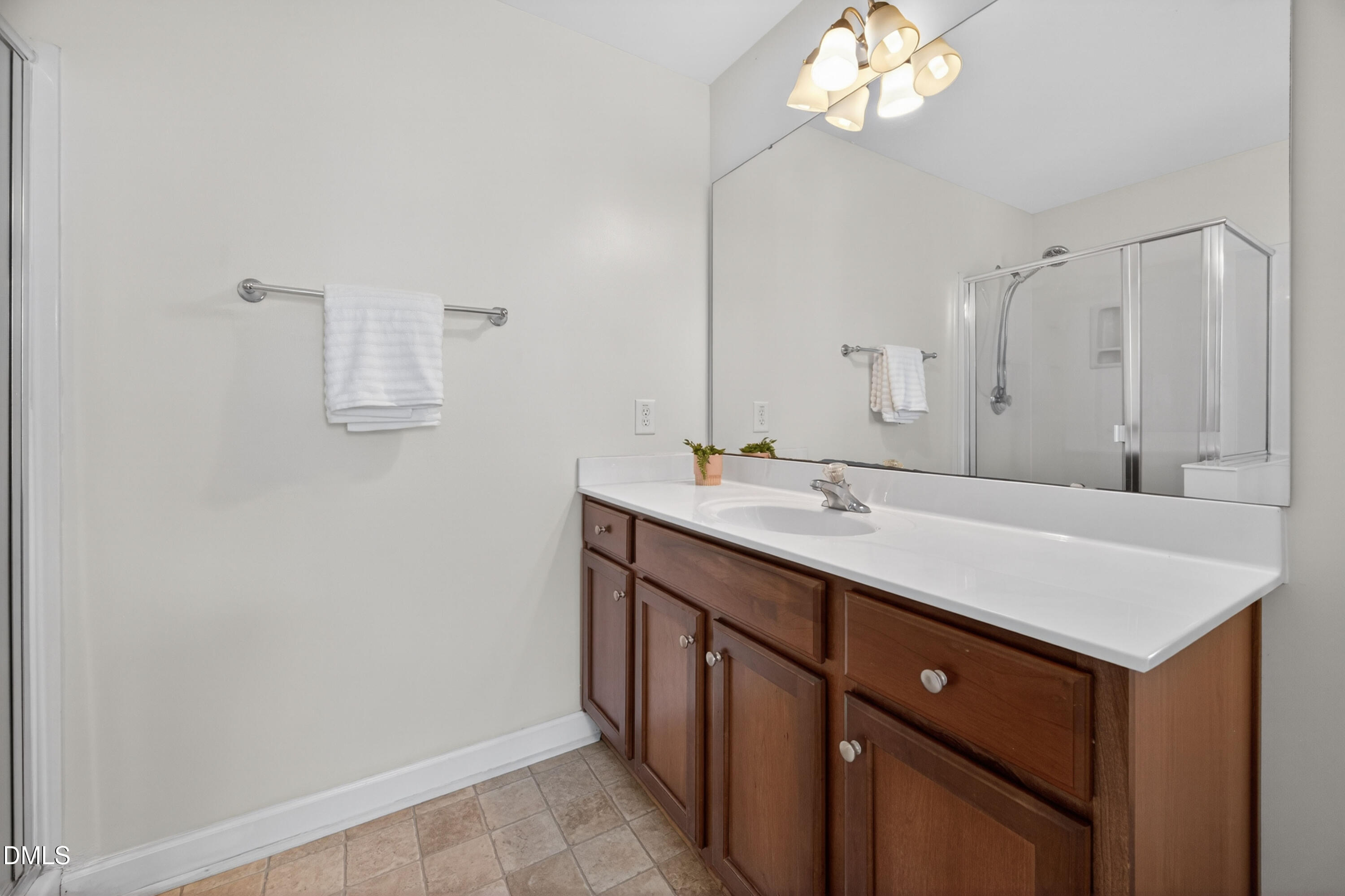 5304 Stone Station Drive Raleigh, NC 27616 - Photo 16 of 34 a bathroom with a sink a light fixture and a mirror