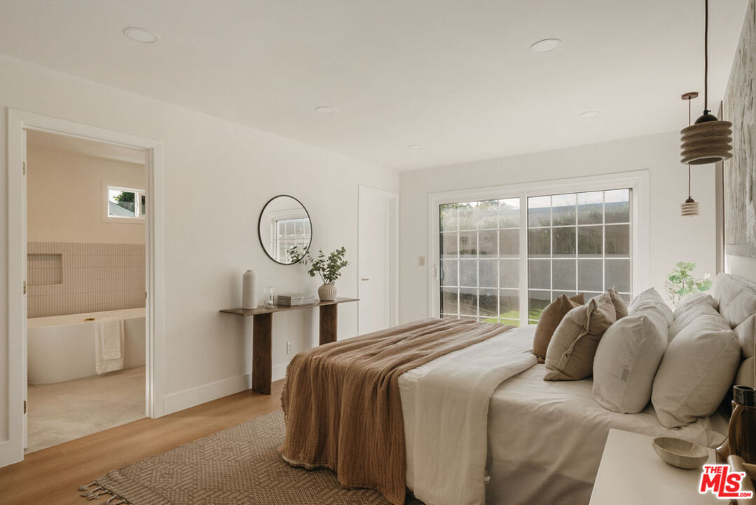 1525 Rogue Street Placentia, CA 92870 - Photo 25 of 40 a bedroom with a bed a mirror and a window