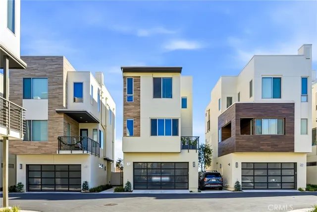 a front view of residential houses with stairs