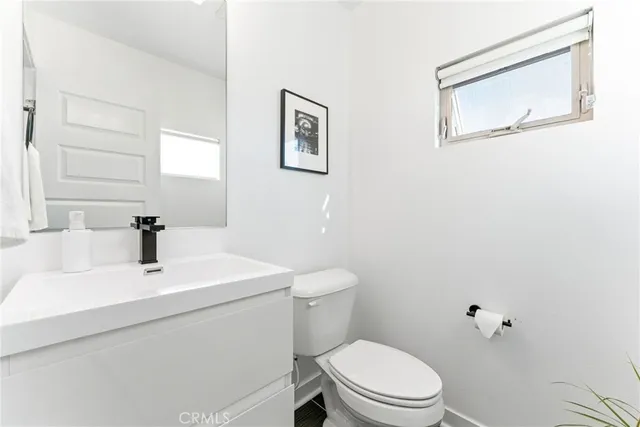 a bathroom with a sink mirror and toilet