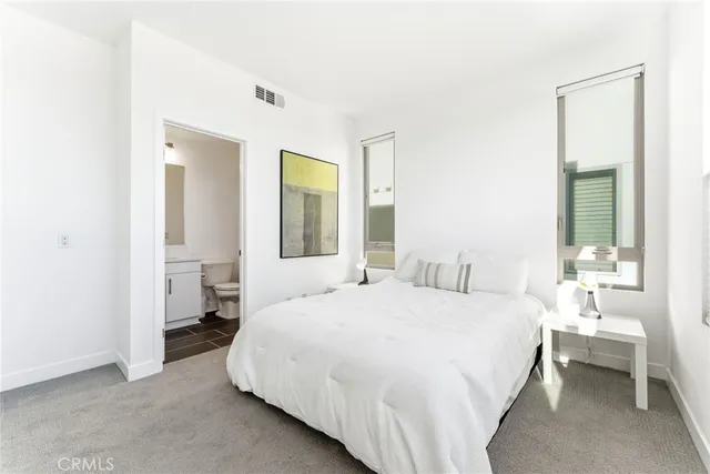 a bedroom with a bed and a large mirror