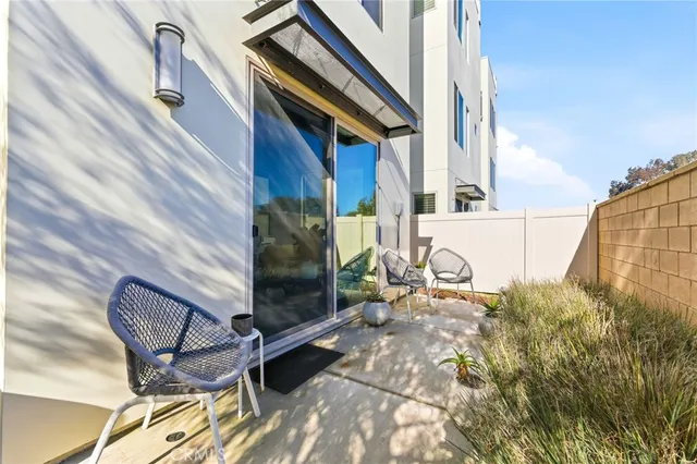 a backyard of a house with table and chairs