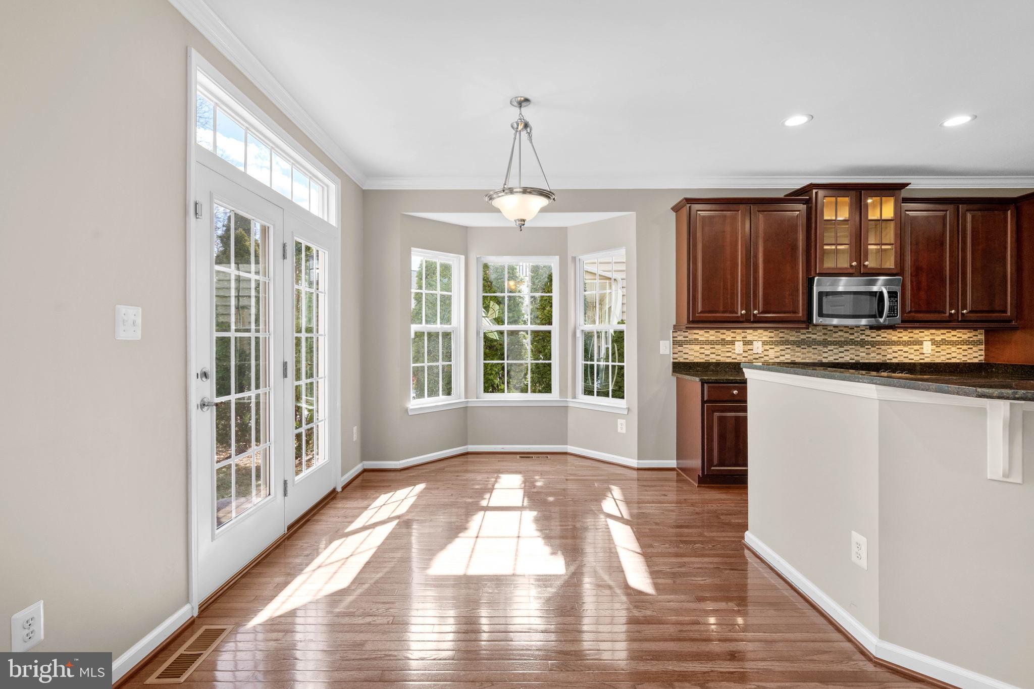 3614 Coatesly Drive Chantilly, VA 20151 - Photo 16 of 51 a view of a kitchen with granite countertop a stove top oven a sink with wooden floor and cabinets