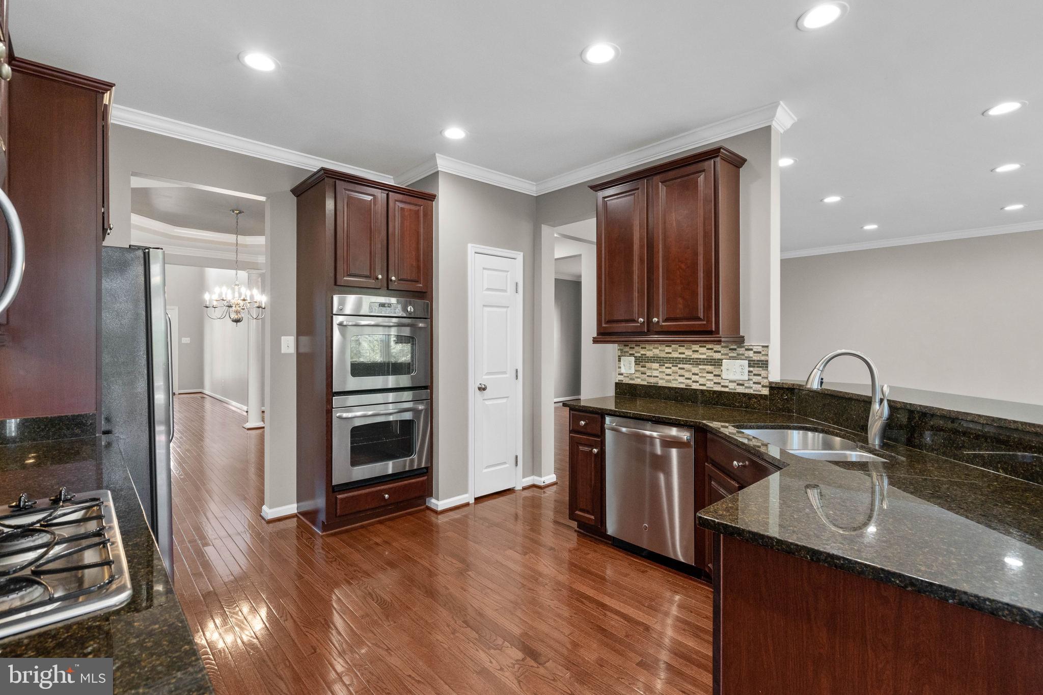 3614 Coatesly Drive Chantilly, VA 20151 - Photo 18 of 51 a kitchen with stainless steel appliances granite countertop a sink stove and refrigerator