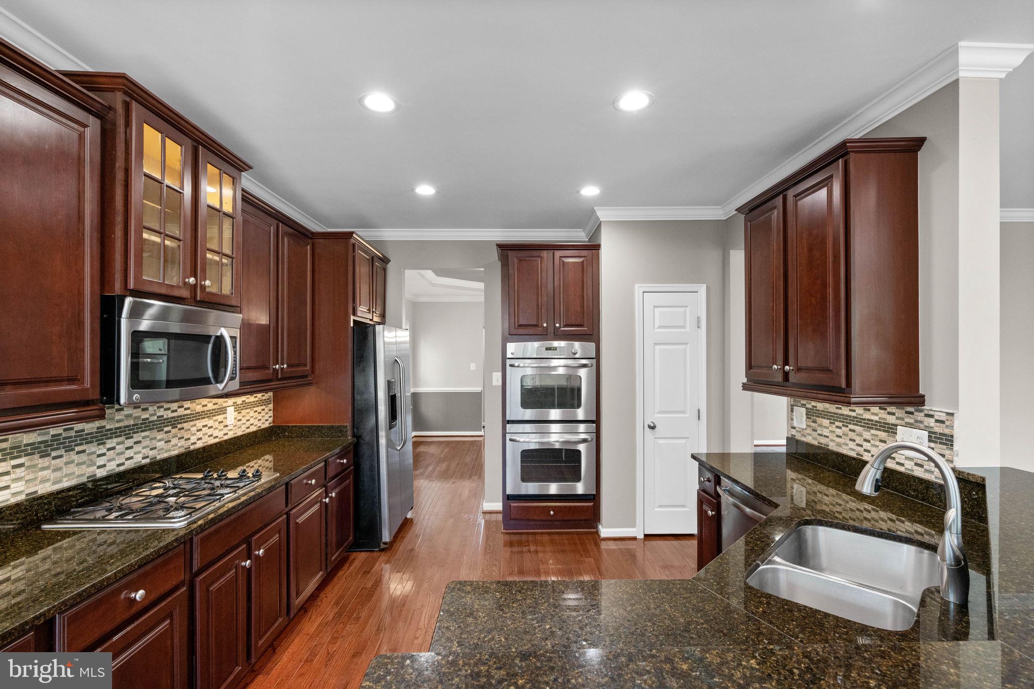 3614 Coatesly Drive Chantilly, VA 20151 - Photo 19 of 51 a kitchen with stainless steel appliances granite countertop a stove refrigerator and microwave