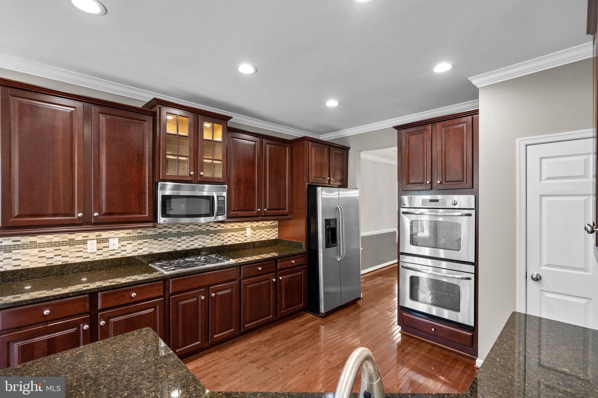 3614 Coatesly Drive Chantilly, VA 20151 - Photo 20 of 51 a kitchen with stainless steel appliances granite countertop a refrigerator and a stove top oven