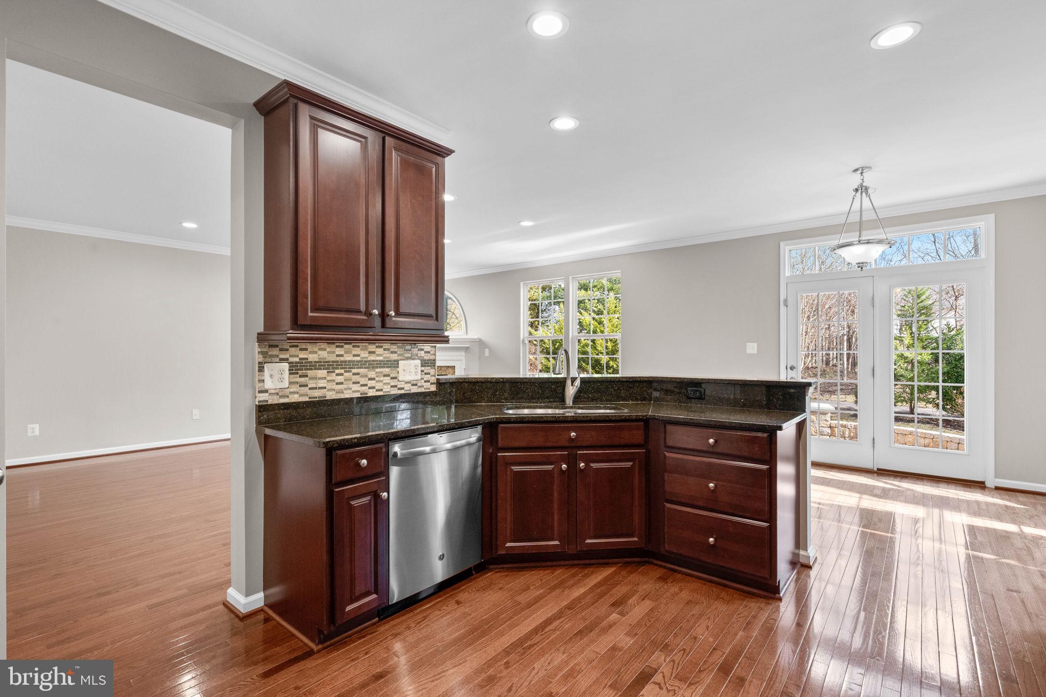 3614 Coatesly Drive Chantilly, VA 20151 - Photo 21 of 51 a kitchen with granite countertop wooden cabinets and a wooden floor