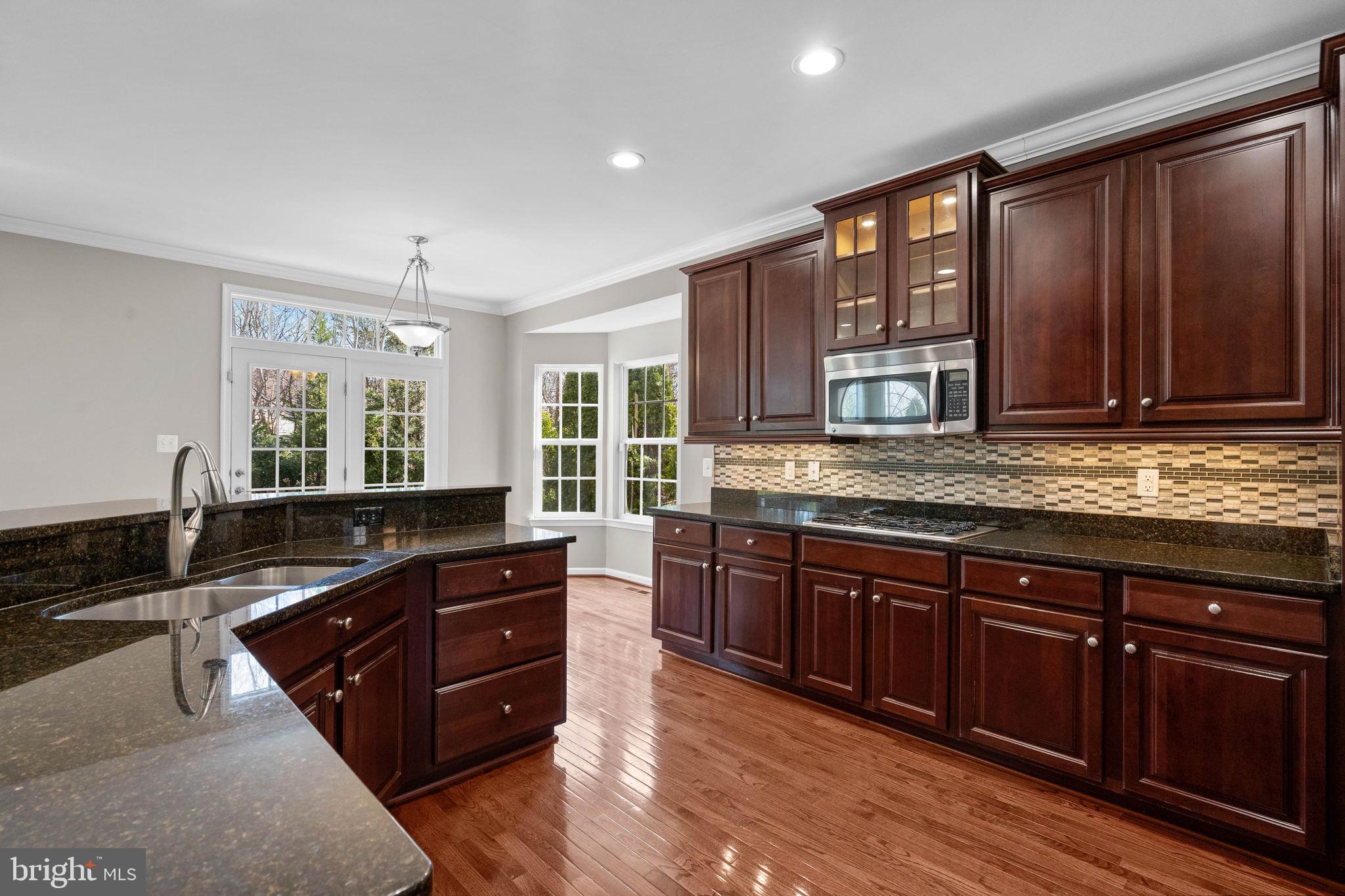 3614 Coatesly Drive Chantilly, VA 20151 - Photo 22 of 51 a kitchen with granite countertop wooden cabinets and a sink