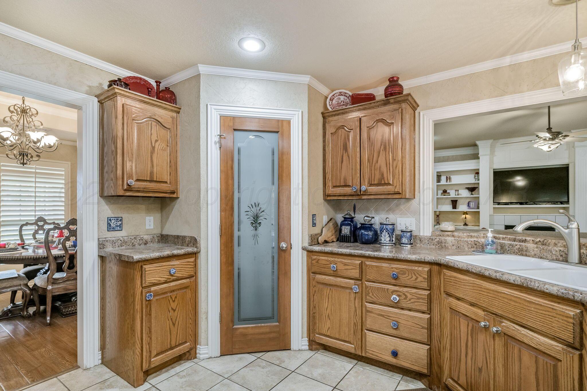6007 Hunter Drive Amarillo, TX 79119 - Photo 12 of 28 a bathroom with a sink a mirror and a shower