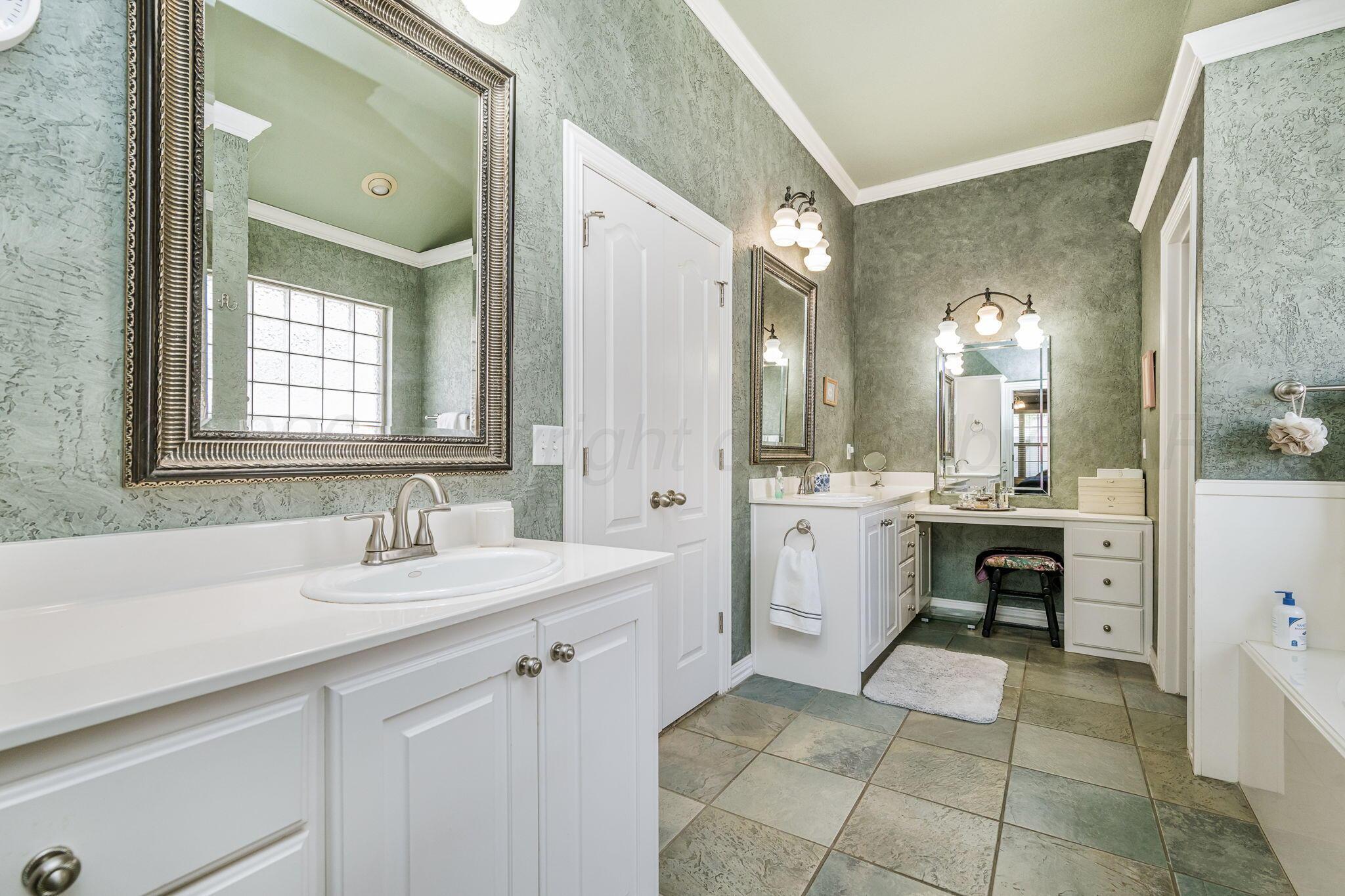 6007 Hunter Drive Amarillo, TX 79119 - Photo 17 of 28 a spacious bathroom with a double vanity sink mirror and