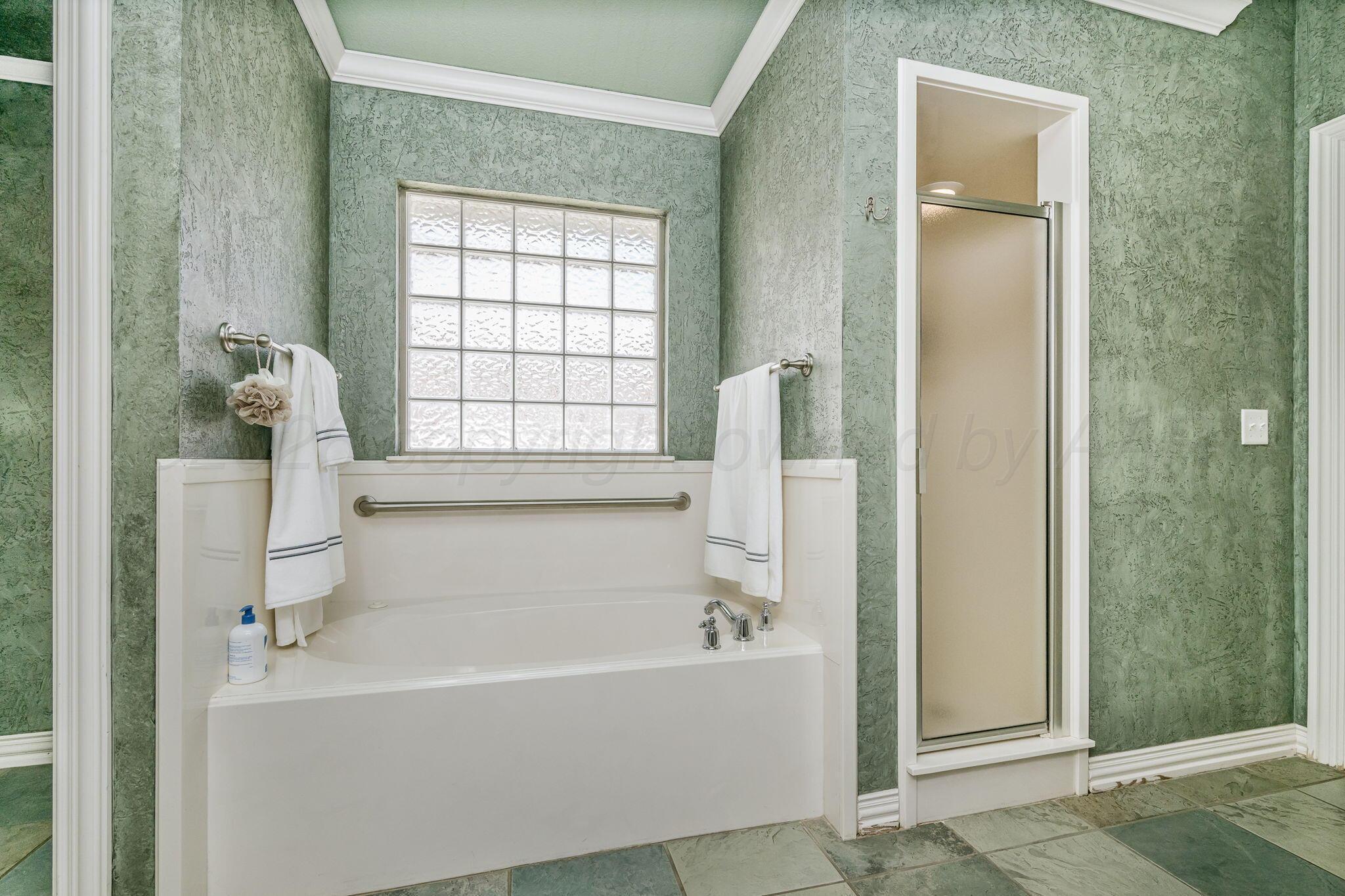 6007 Hunter Drive Amarillo, TX 79119 - Photo 18 of 28 a white bath tub sitting next to a window