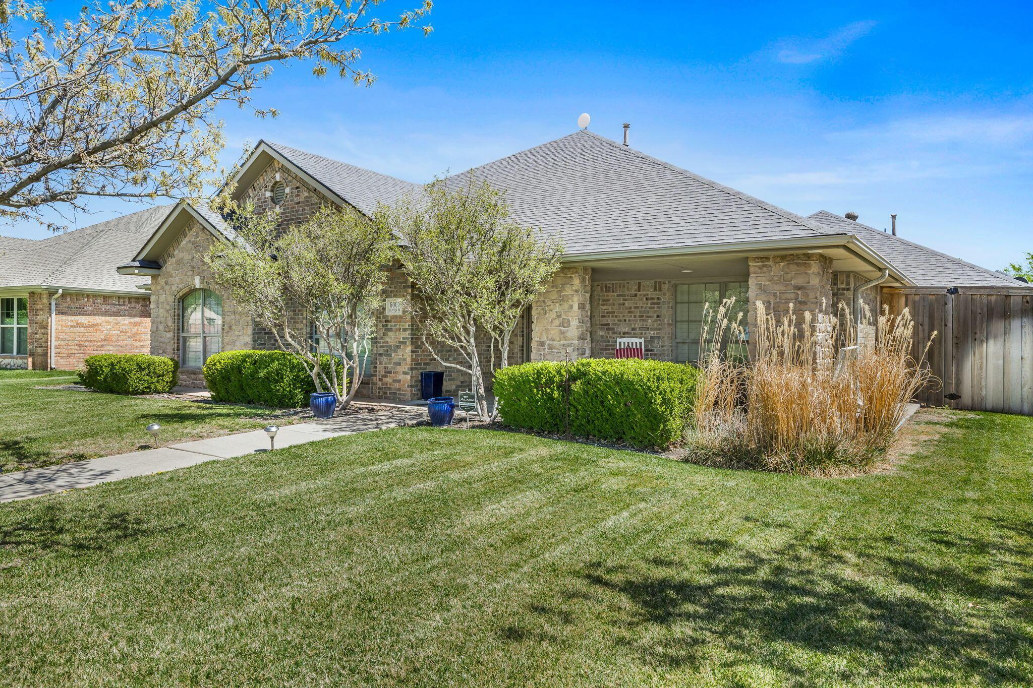 6007 Hunter Drive Amarillo, TX 79119 - Photo 2 of 28 a view of a house with backyard and garden