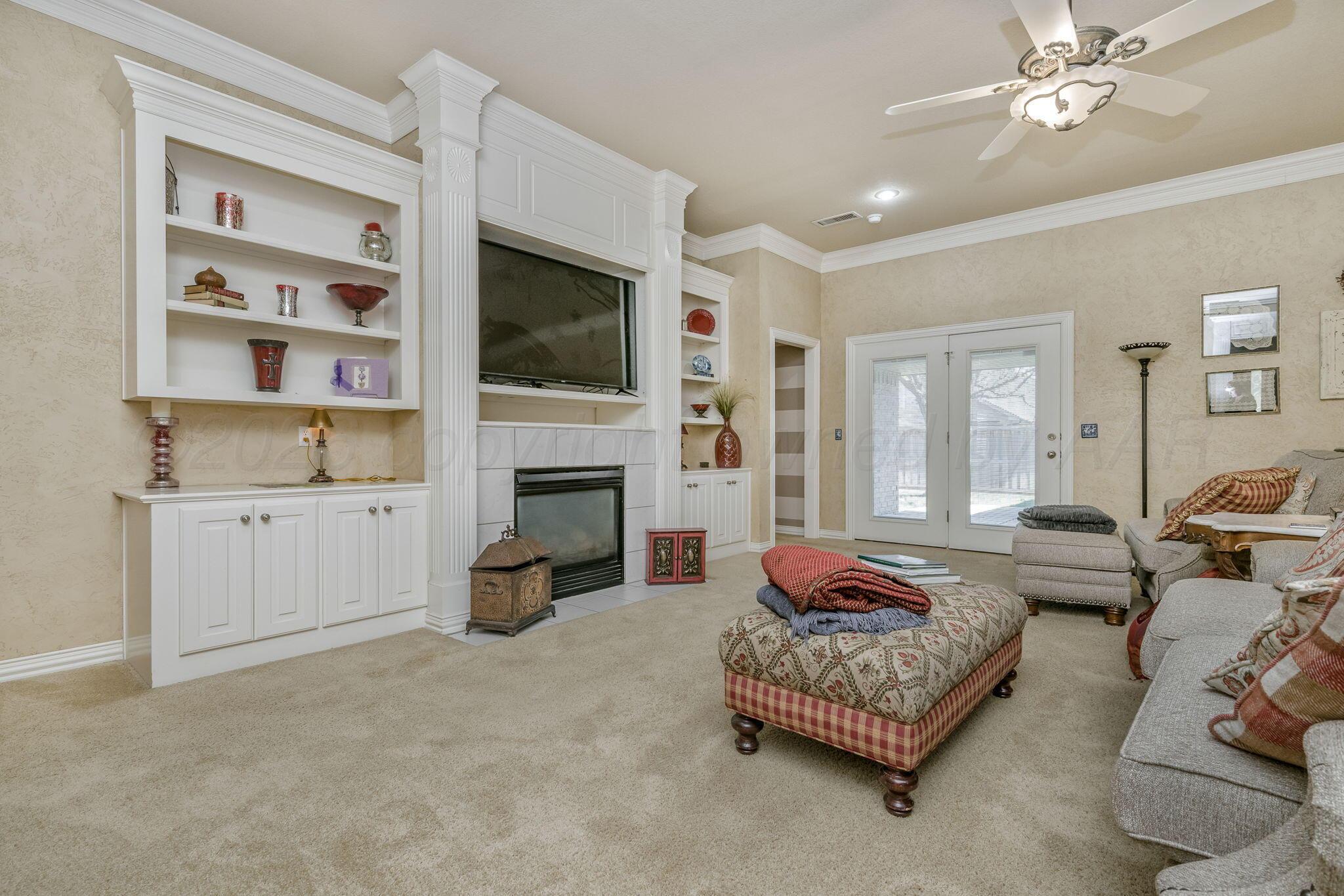 6007 Hunter Drive Amarillo, TX 79119 - Photo 5 of 28 a living room with furniture fireplace and a flat screen tv