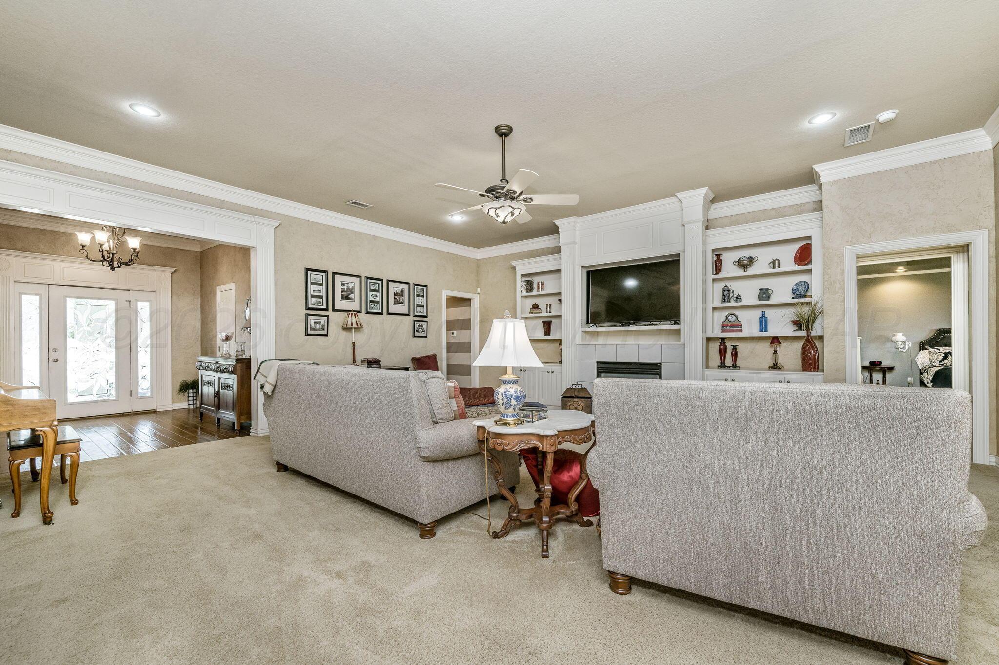 6007 Hunter Drive Amarillo, TX 79119 - Photo 7 of 28 a living room with furniture and a flat screen tv