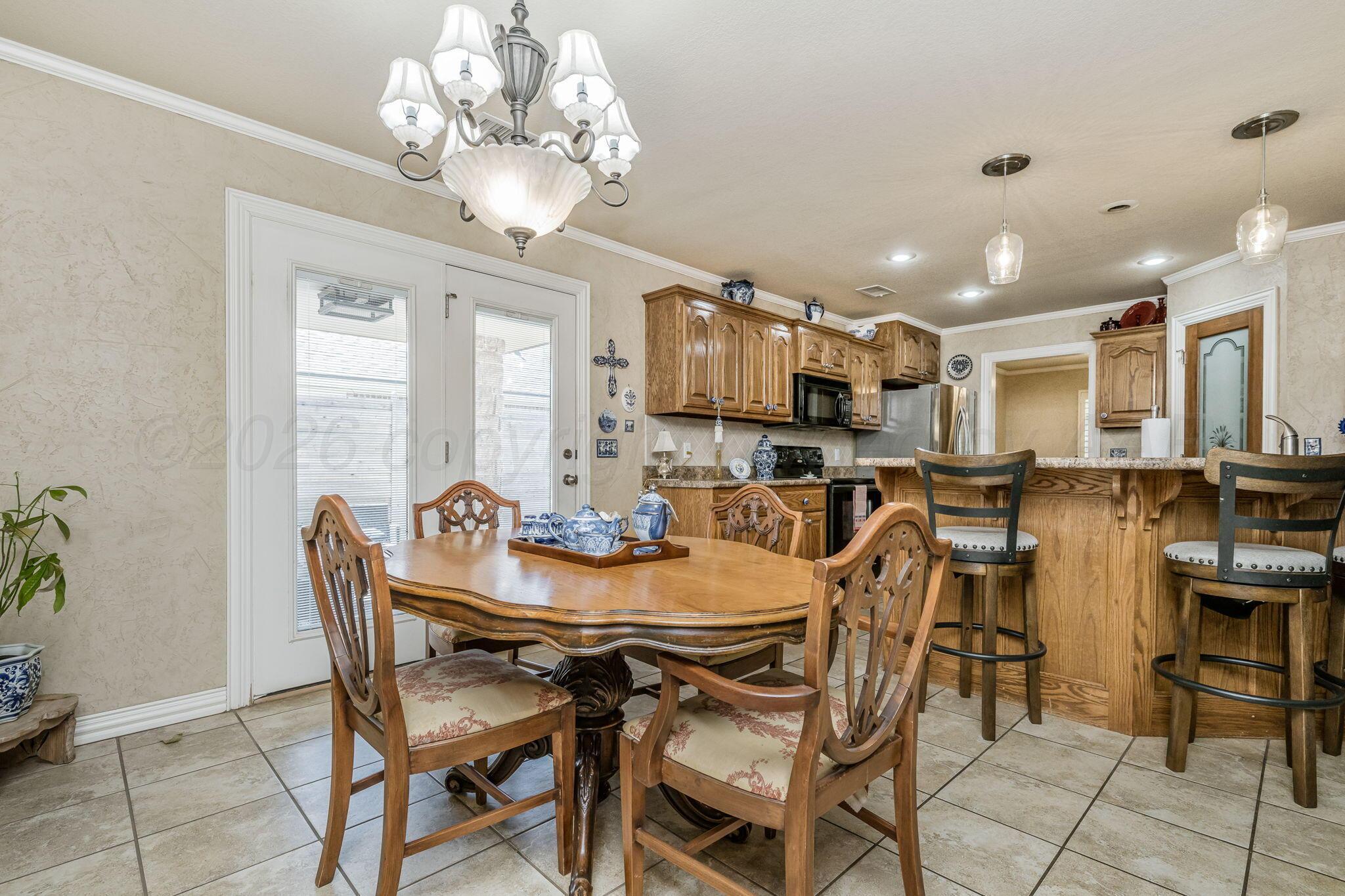 6007 Hunter Drive Amarillo, TX 79119 - Photo 8 of 28 a view of a dining room with furniture and chandelier