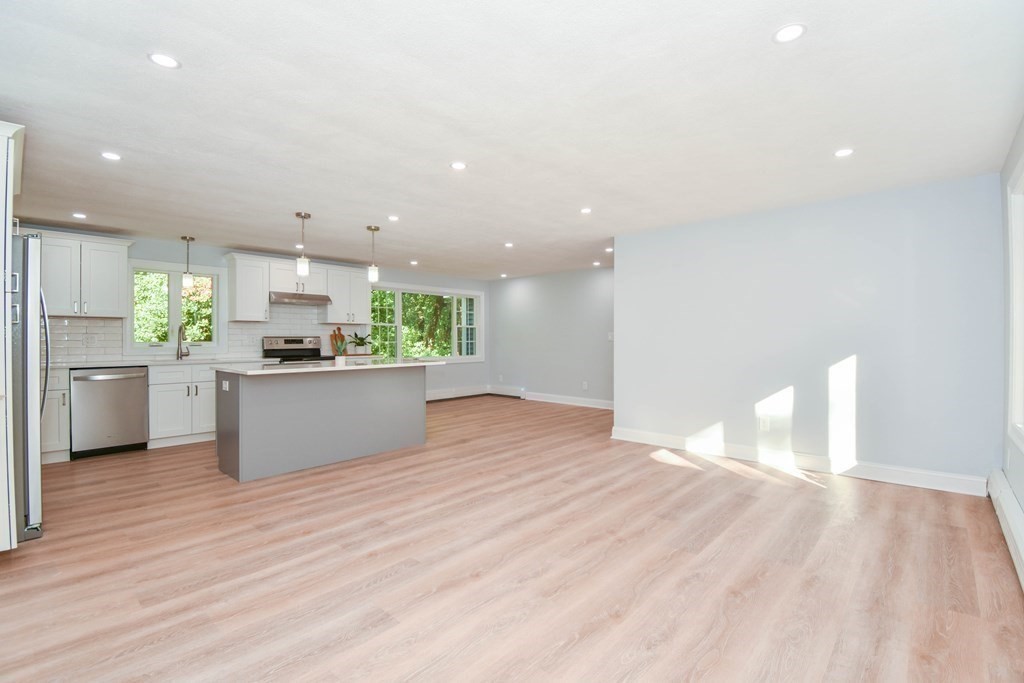 26 Juniper Lane Framingham, MA 01701 - Photo 6 of 26 a kitchen with stainless steel appliances kitchen island a refrigerator sink and cabinets