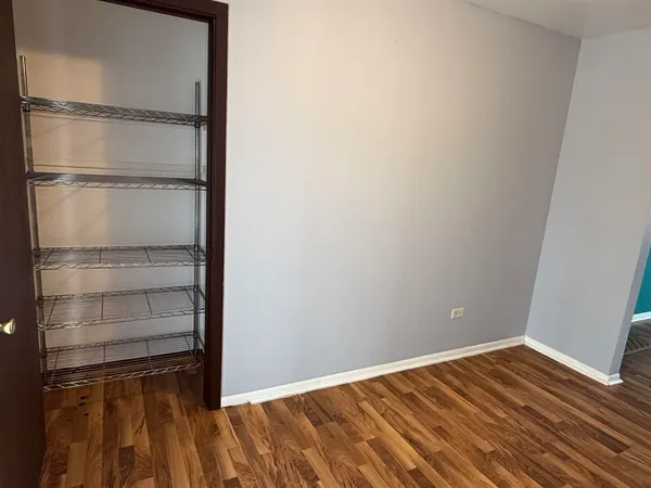 a view of a room with wooden floor