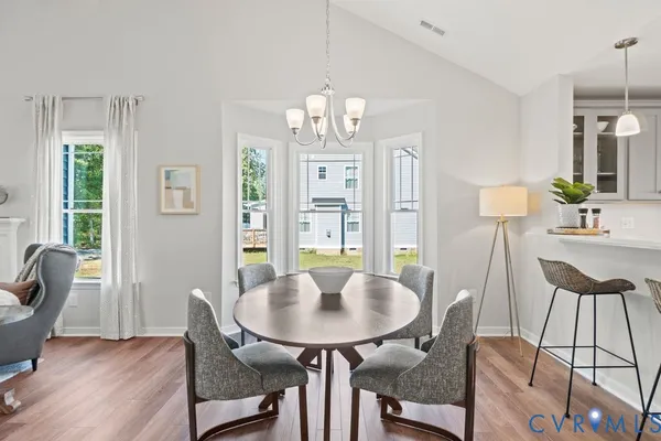 a view of a dining room with furniture window and wooden floor