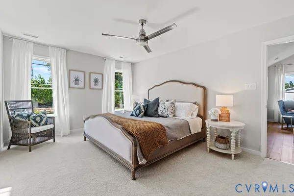 a bedroom with a bed a couch and a window