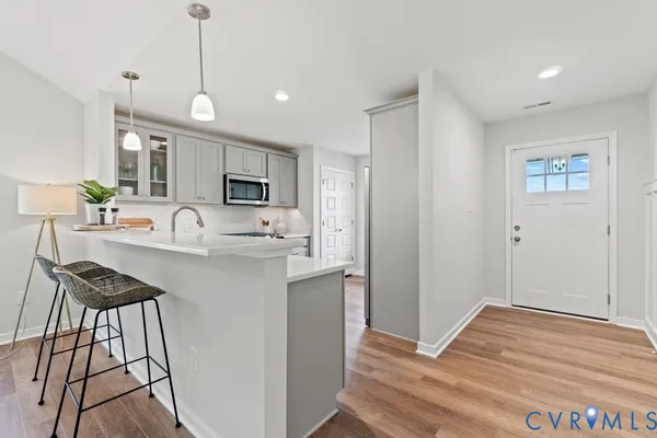 a kitchen with stainless steel appliances granite countertop a sink and a refrigerator