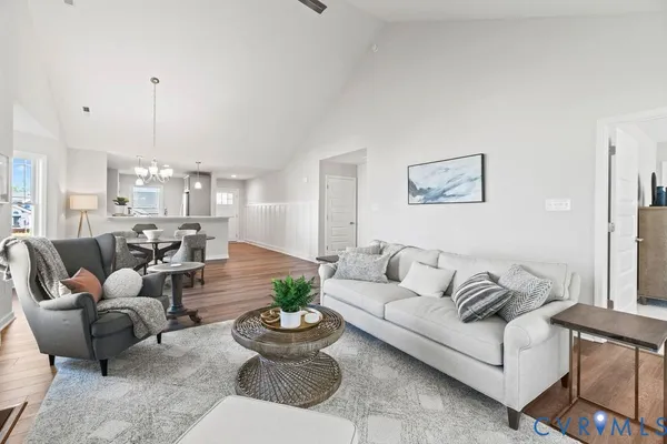 a living room with furniture and a chandelier
