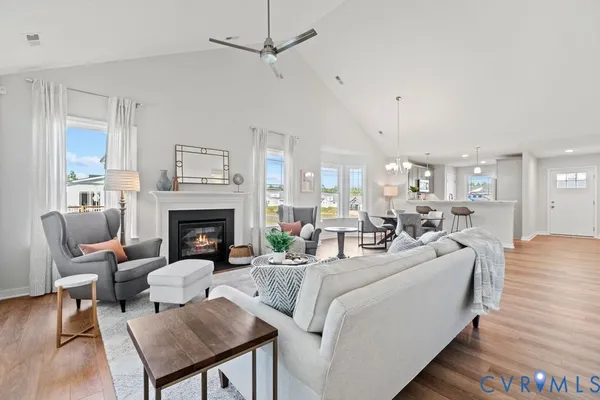 a living room with furniture a fireplace and a table