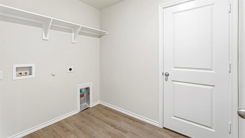 3519 Spring Time Street Forney, TX 75126 - Photo 27 of 37 Utility room featuring wood-finish flooring, white baseboards, and light neutral wall paint