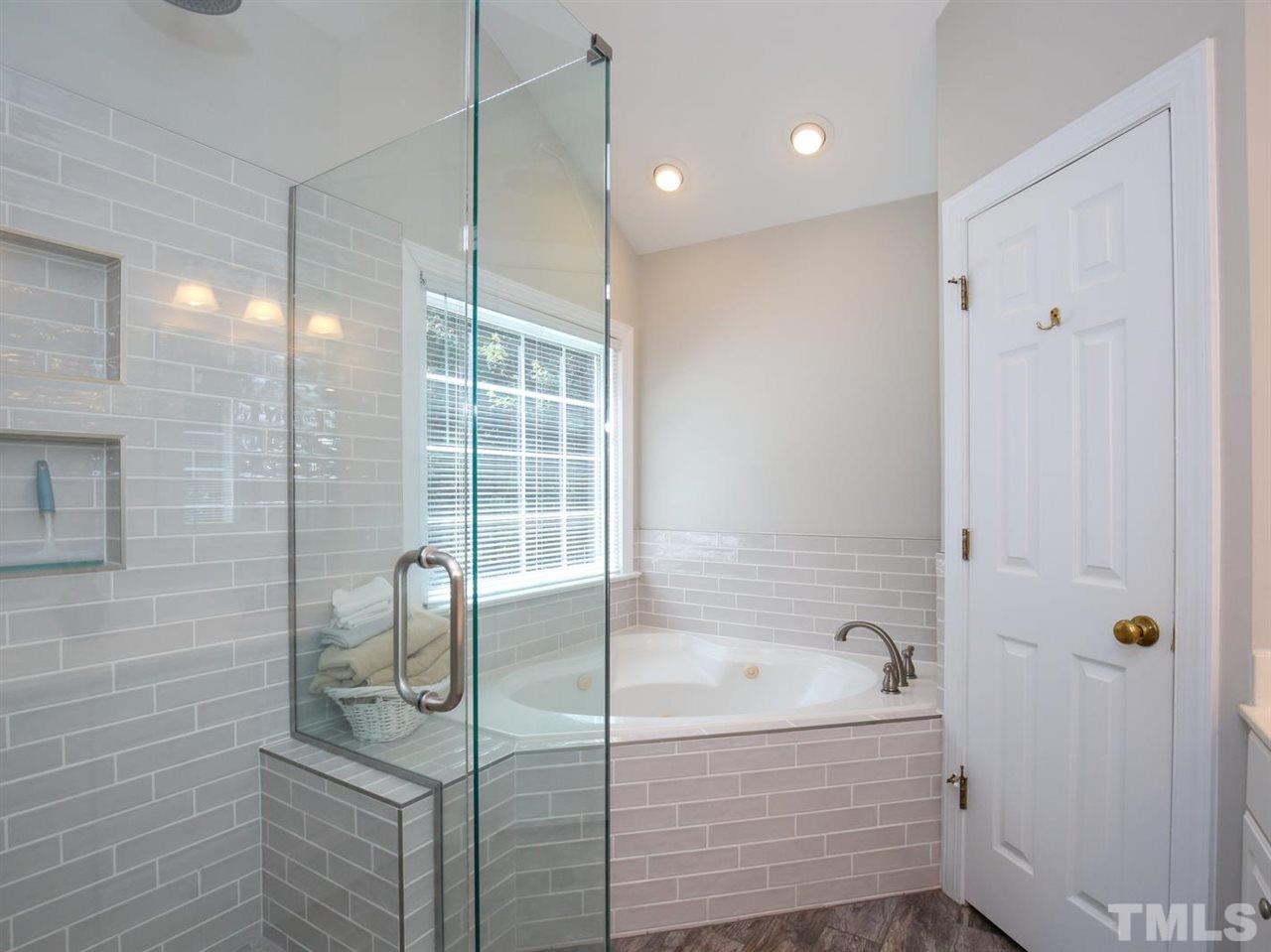 2329 Finley Ridge Lane Raleigh, NC 27615 - Photo 17 of 27 a bathroom with a bathtub and shower