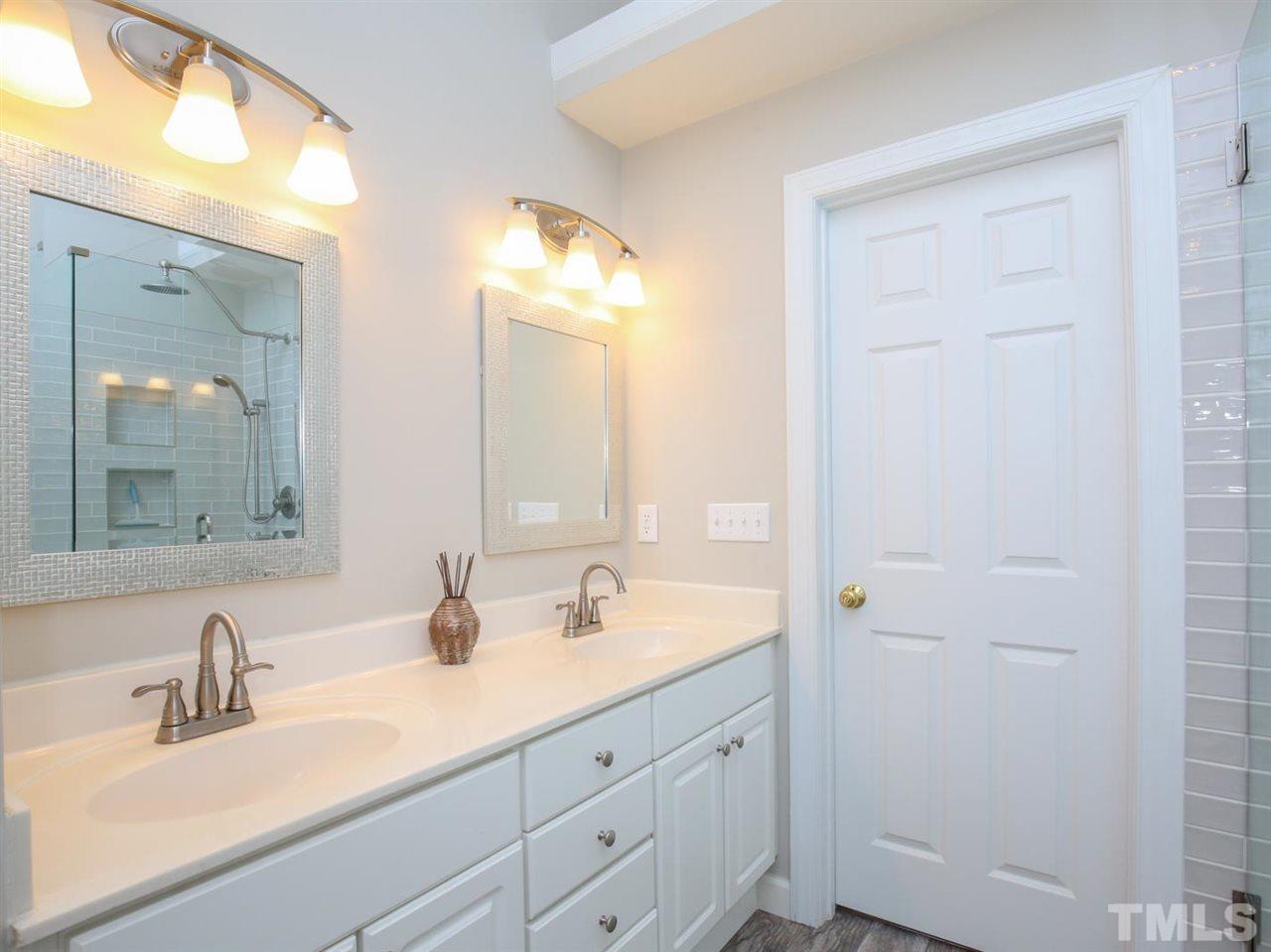2329 Finley Ridge Lane Raleigh, NC 27615 - Photo 18 of 27 a bathroom with a double vanity sink and a mirror