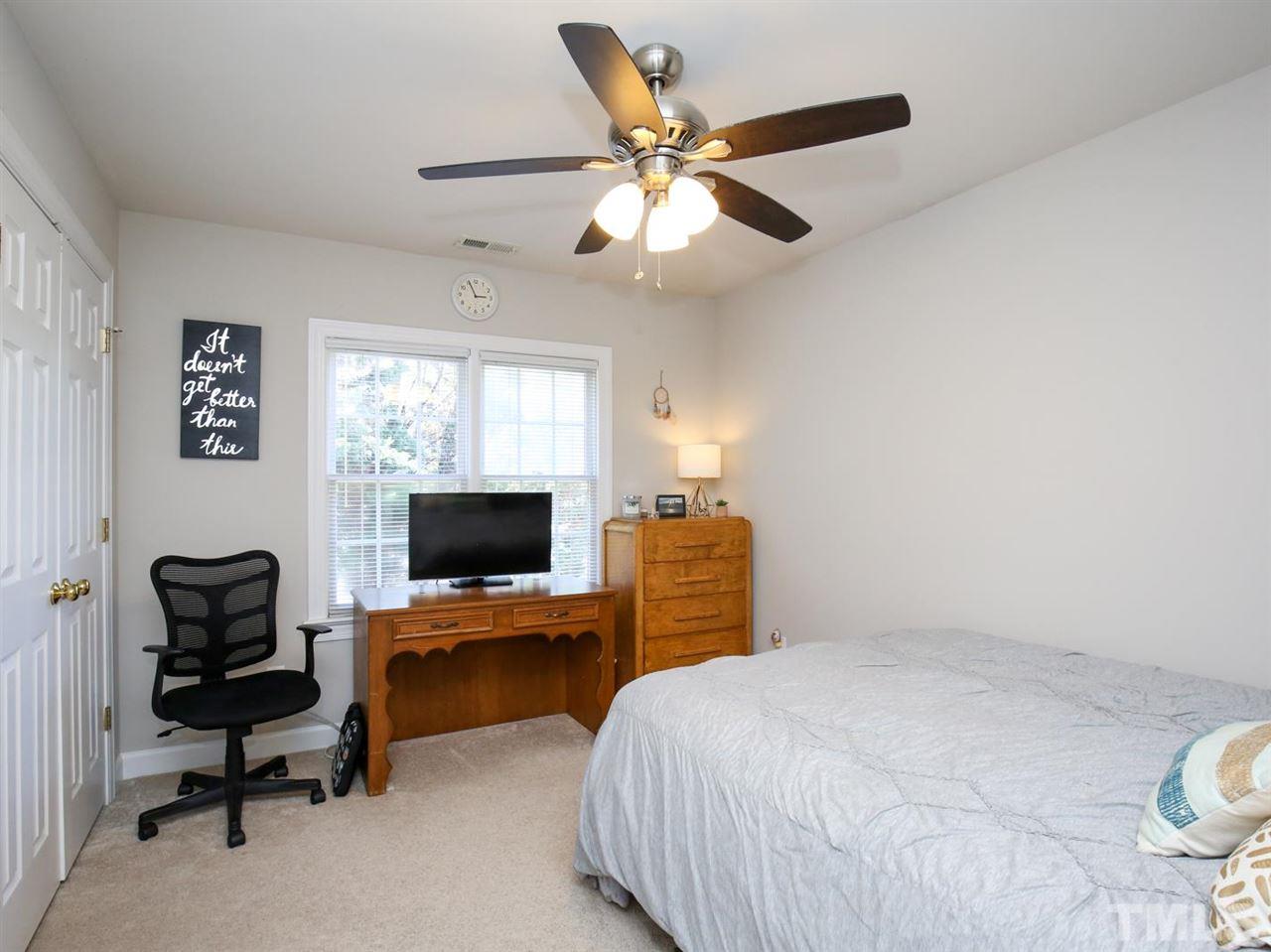 2329 Finley Ridge Lane Raleigh, NC 27615 - Photo 21 of 27 a bedroom with a bed and wooden floor
