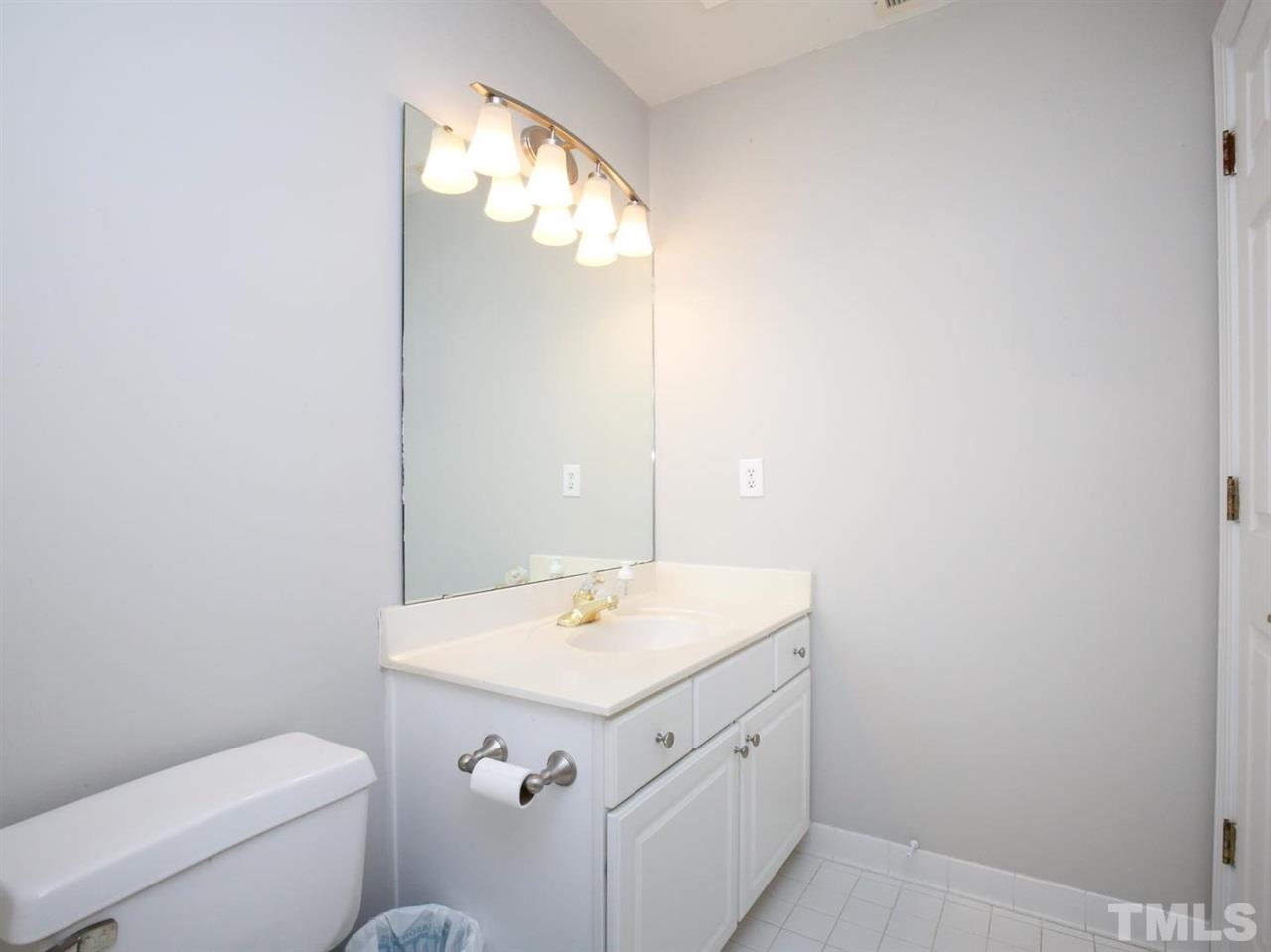 2329 Finley Ridge Lane Raleigh, NC 27615 - Photo 22 of 27 a bathroom with a sink a toilet and a mirror