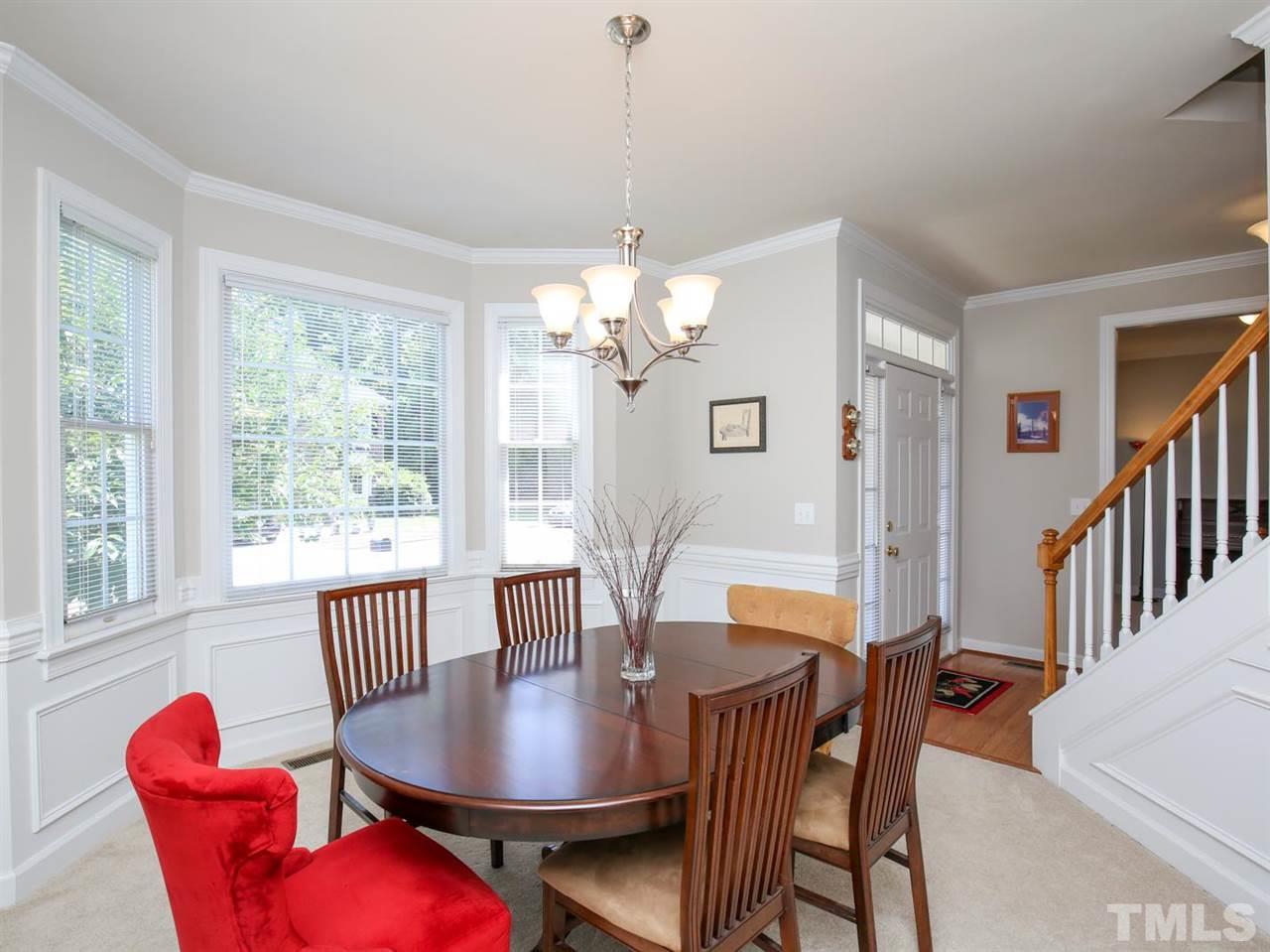 2329 Finley Ridge Lane Raleigh, NC 27615 - Photo 4 of 27 a view of a dining room with furniture a chandelier and wooden floor