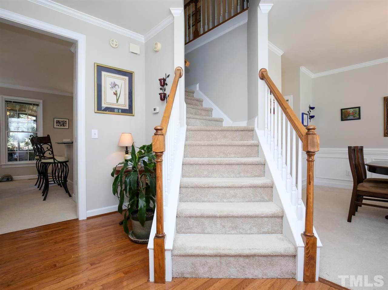 2329 Finley Ridge Lane Raleigh, NC 27615 - Photo 6 of 27 a view of staircase with wooden floor and a potted plant