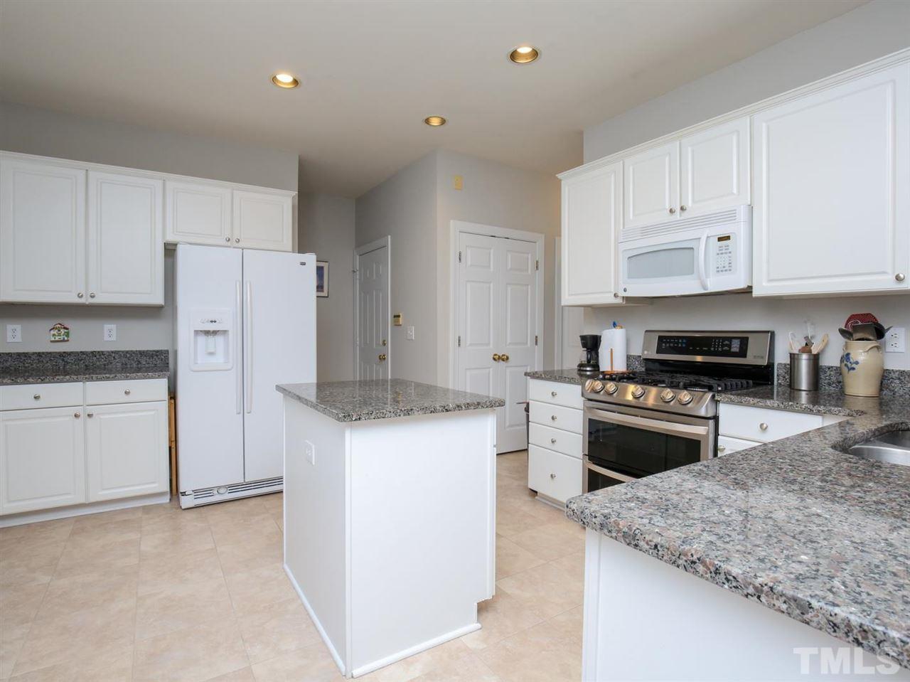 2329 Finley Ridge Lane Raleigh, NC 27615 - Photo 10 of 27 a kitchen with granite countertop white cabinets and white appliances