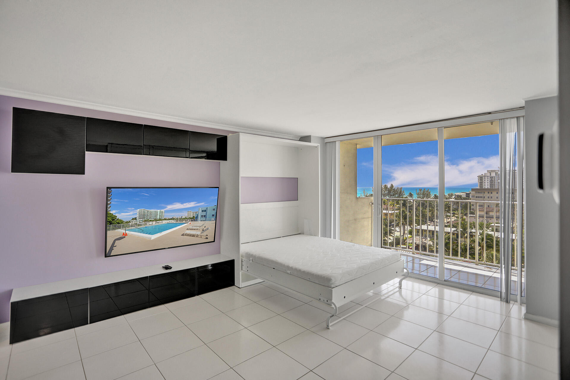 111 Briny Avenue, Unit 810 Pompano Beach, FL 33062 - Photo 3 of 62 a bedroom with a bed and a view of balcony