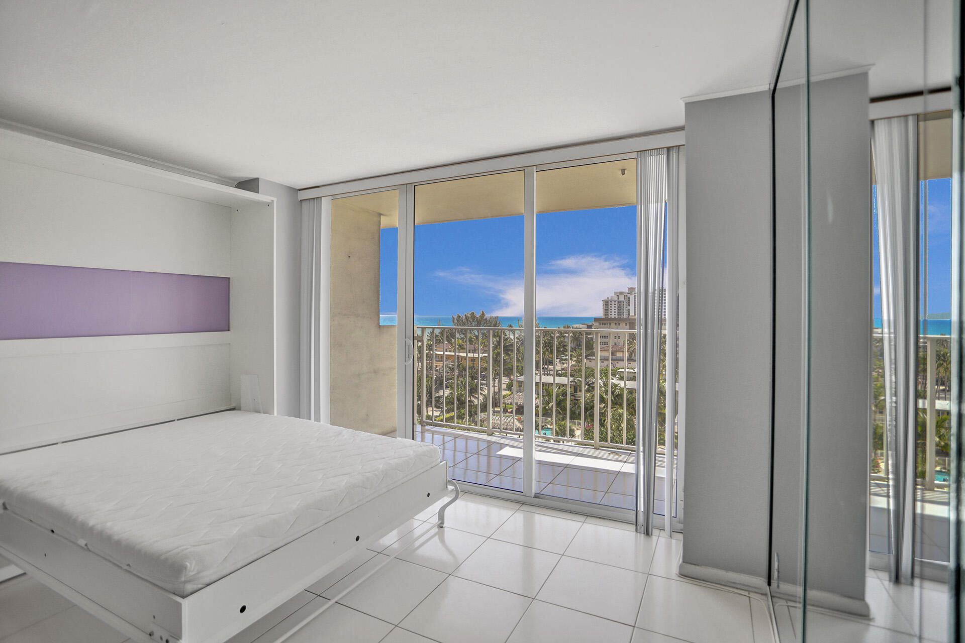 111 Briny Avenue, Unit 810 Pompano Beach, FL 33062 - Photo 4 of 62 a bedroom with a bed and a window