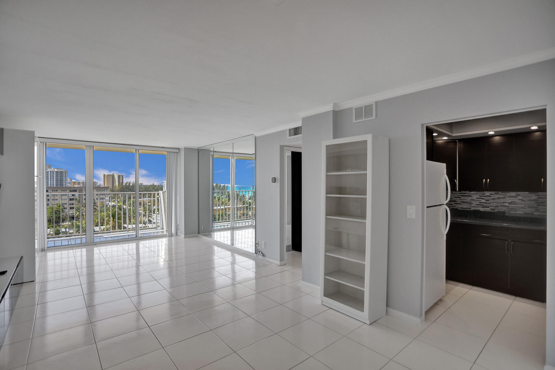 111 Briny Avenue, Unit 810 Pompano Beach, FL 33062 - Photo 10 of 62 a view of an empty room with a kitchen