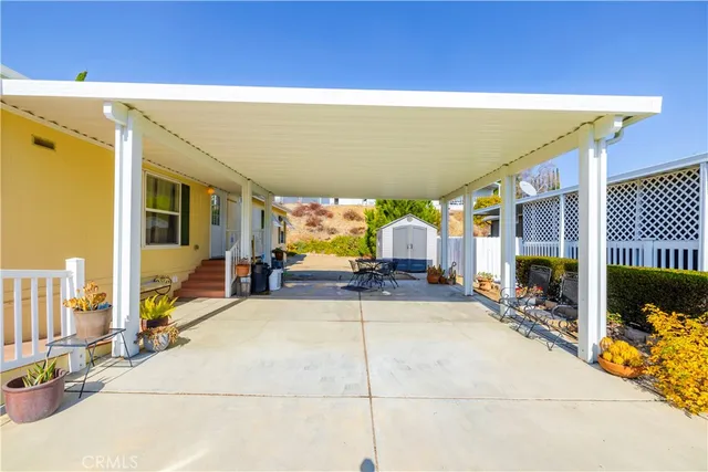 a view of a patio with table and chairs and potted plants